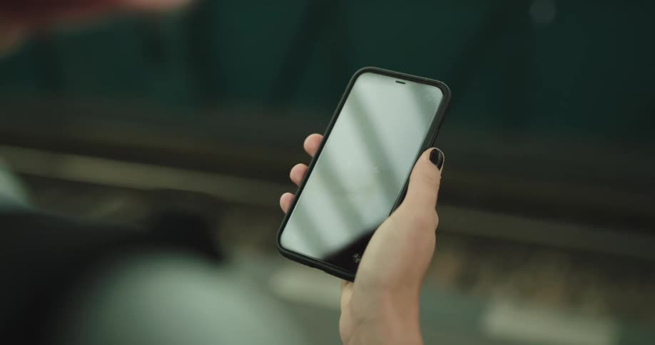 A woman is using a cell phone indoors
