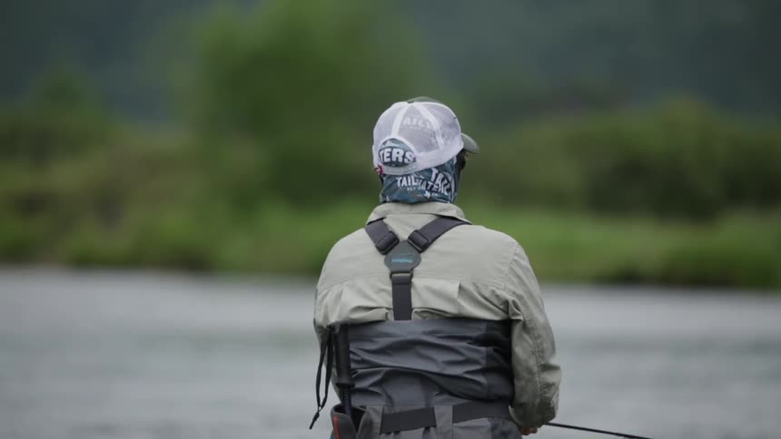 A man is fly fishing in water