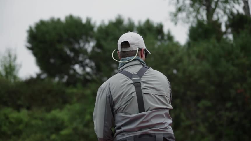 A fisherman works his line