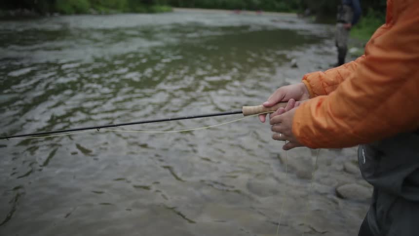 A person adjust the line of a fishing pole