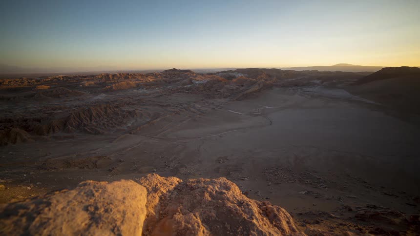 Shadows grow across the Atacama desert terrain as night falls