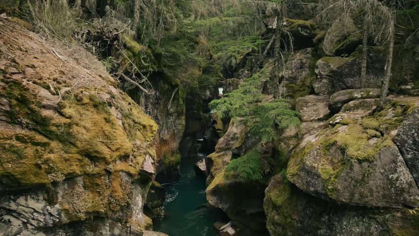 Water is flowing through a rock canyon in the wilderness