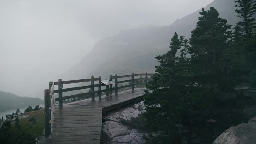 An empty wooden walkway and overlook on a foggy day