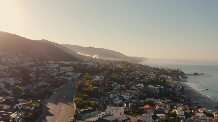An aerial video of a neighborhood next to the ocean