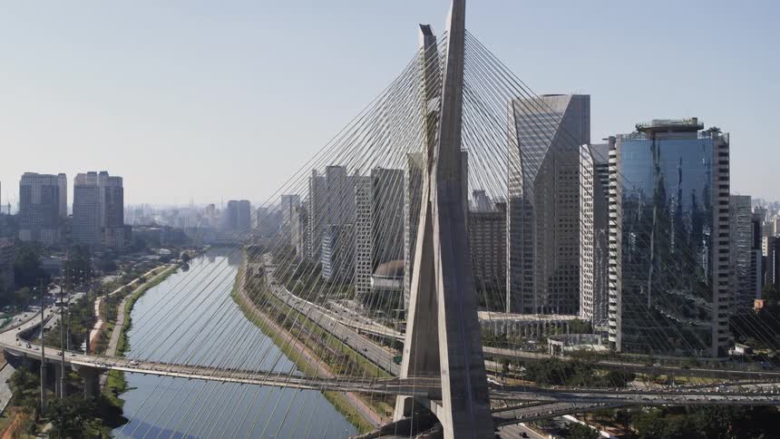 The city is busy with traveling cars behind landmark cable-stayed bridge