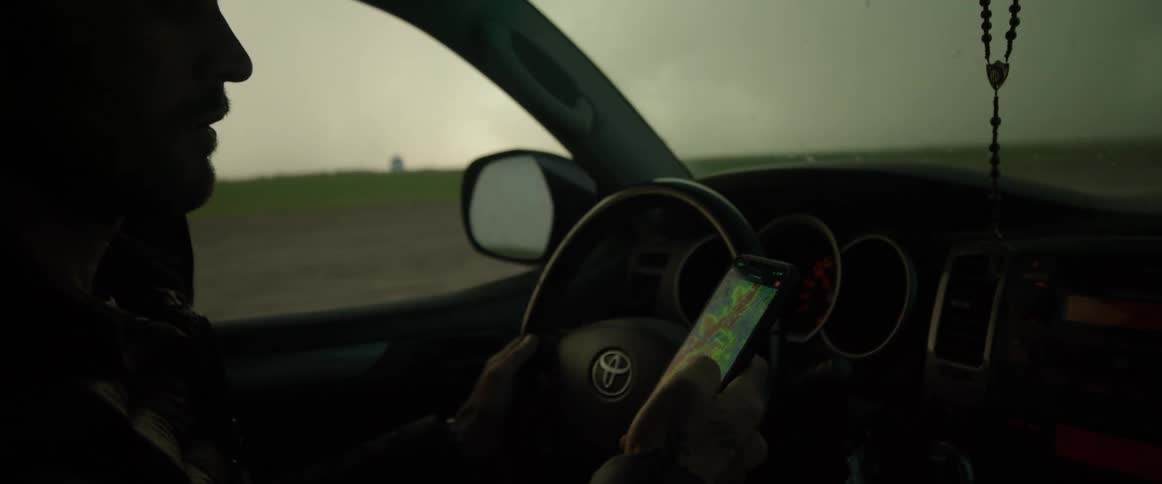 A man is searching around as he drives towards a storm