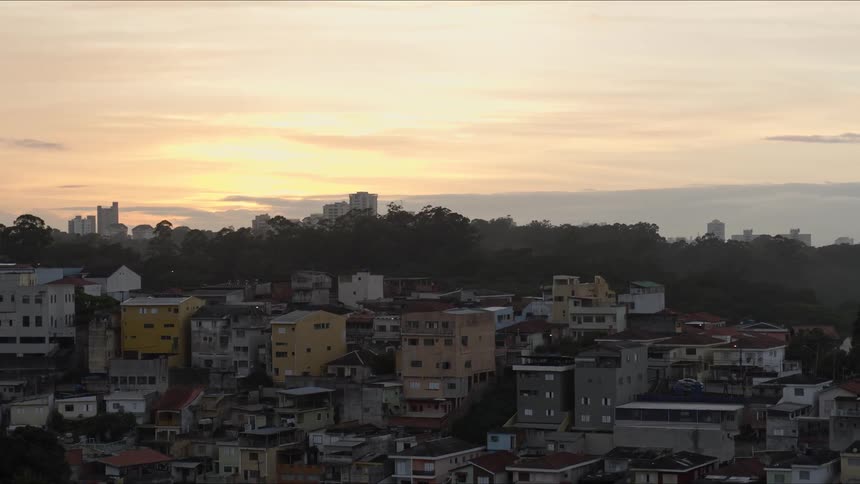 A city skyline with buildings in humble neighborhood at sunset