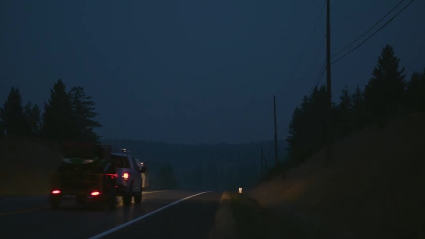 Vehicles travel on the highway at night