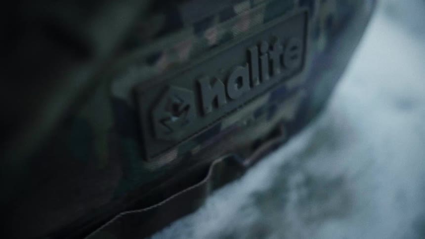 Close up of the label on the side of a camouflaged inflatable raft floating in water