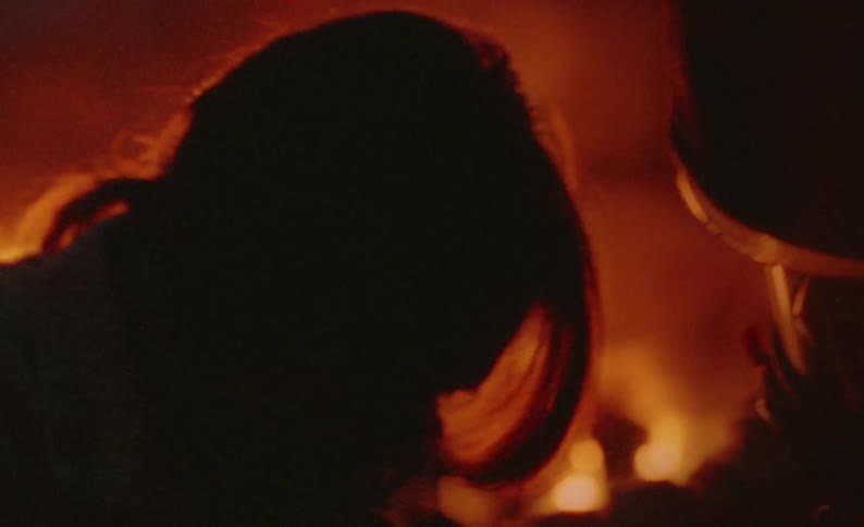 A firefighter is administering aid to a fire victim
