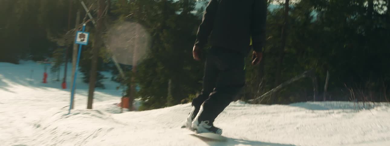 People are snowboarding and skiing down the mountain