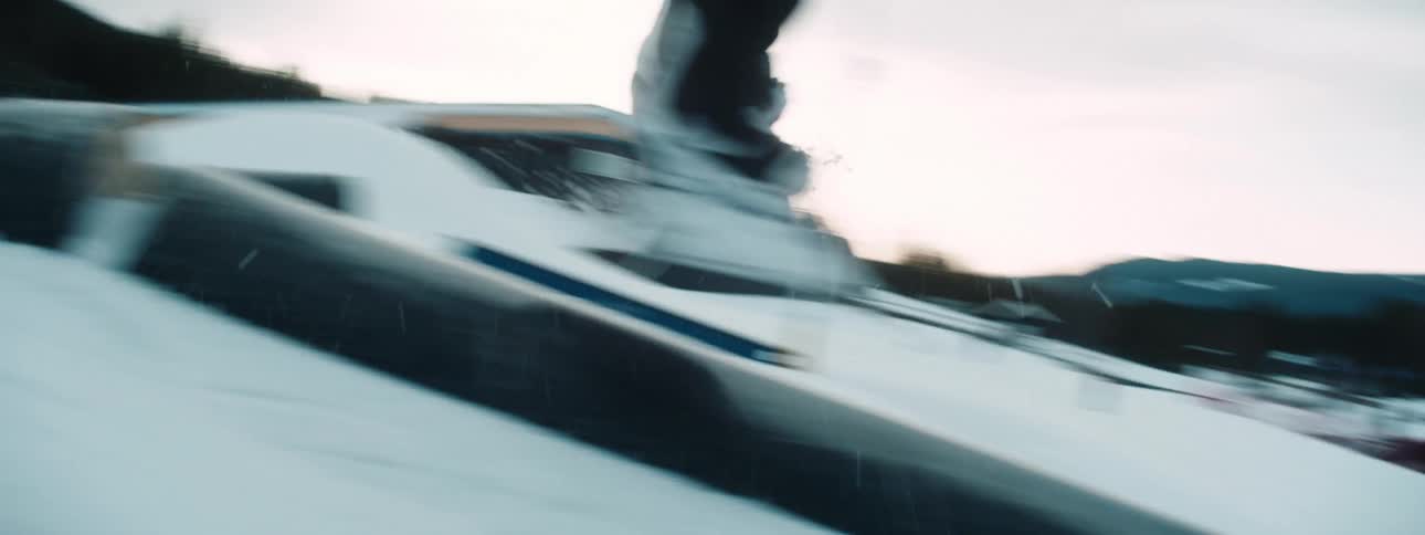 A man does a jump on a rail with his snowboard