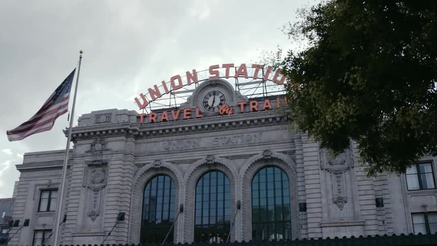 American flag waving in front of the denver union station in colorado