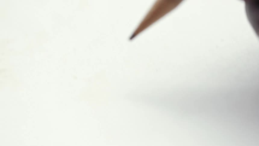 Close up of a hand holding a pencil over a sheet of white paper