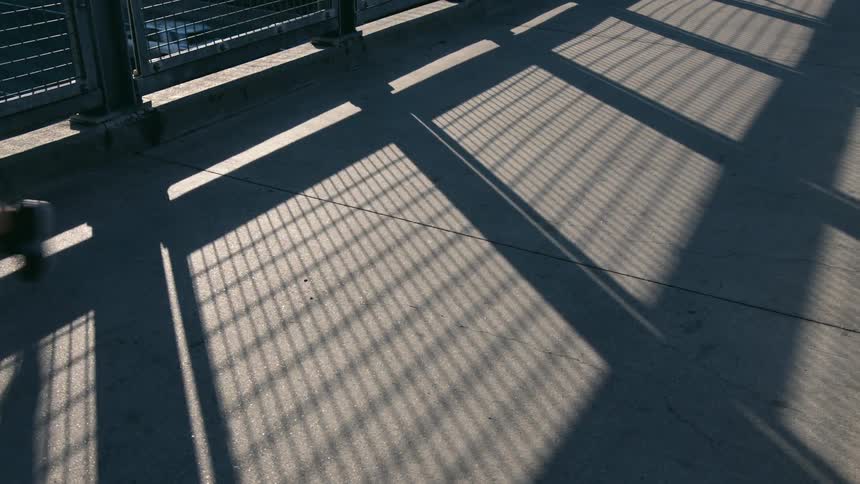 A view of a person running on a bridge