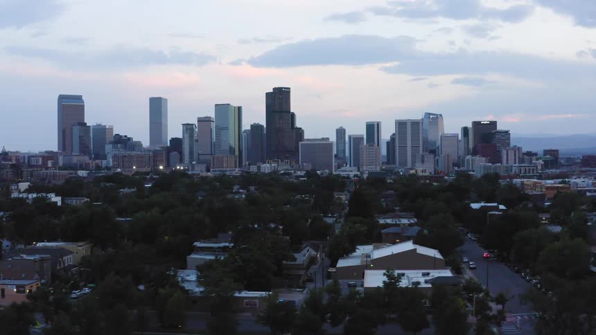 Cityscape with high rise towers and skyscrapers under a cloudy sky