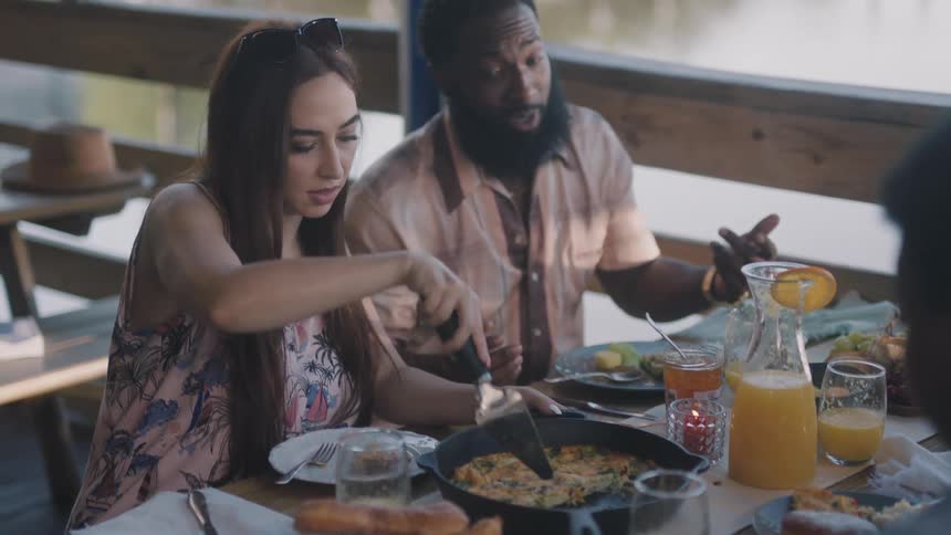 People are sitting down to have food together