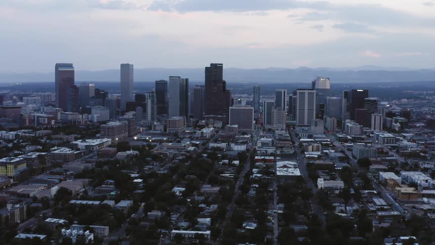 Buildings and skyscrapers in a city skyline on a cloudy evening