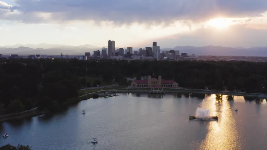 The city is past the body of water at sunrise