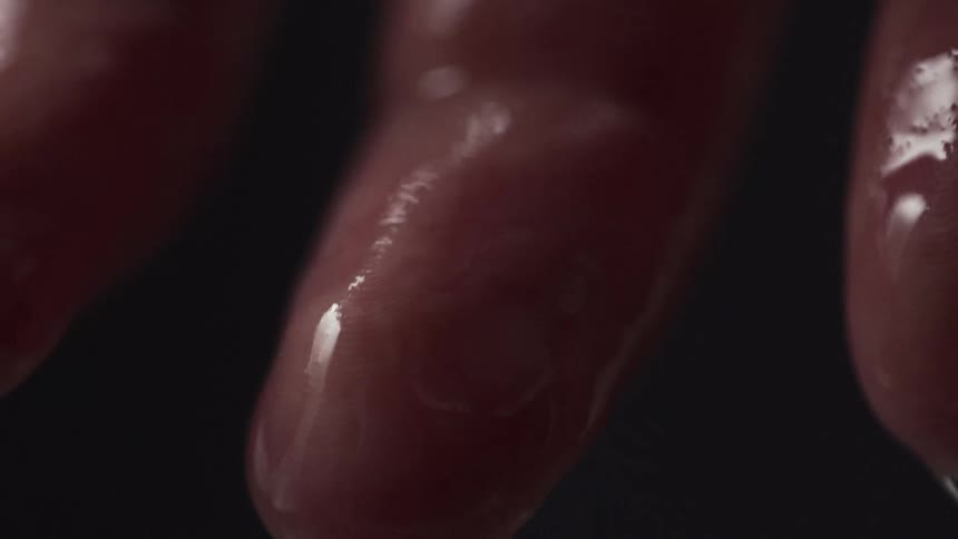 A persons fingers dripping with water
