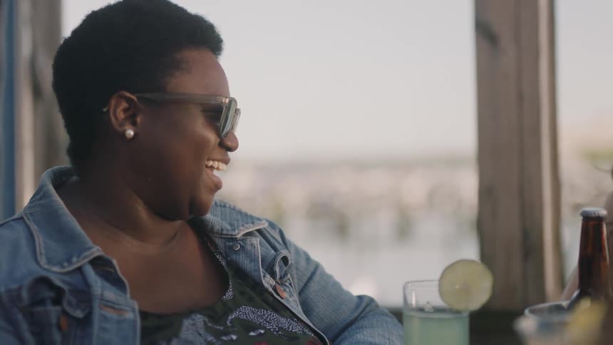 A woman talks with a drink