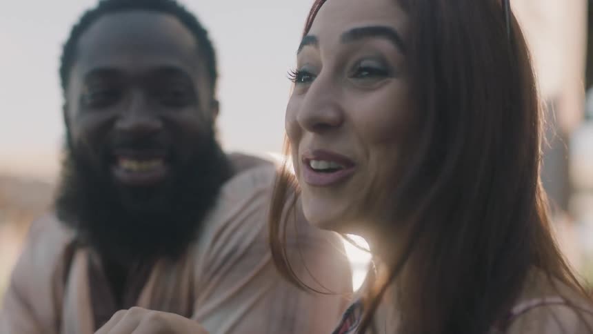 A woman and man talking outdoors laughing