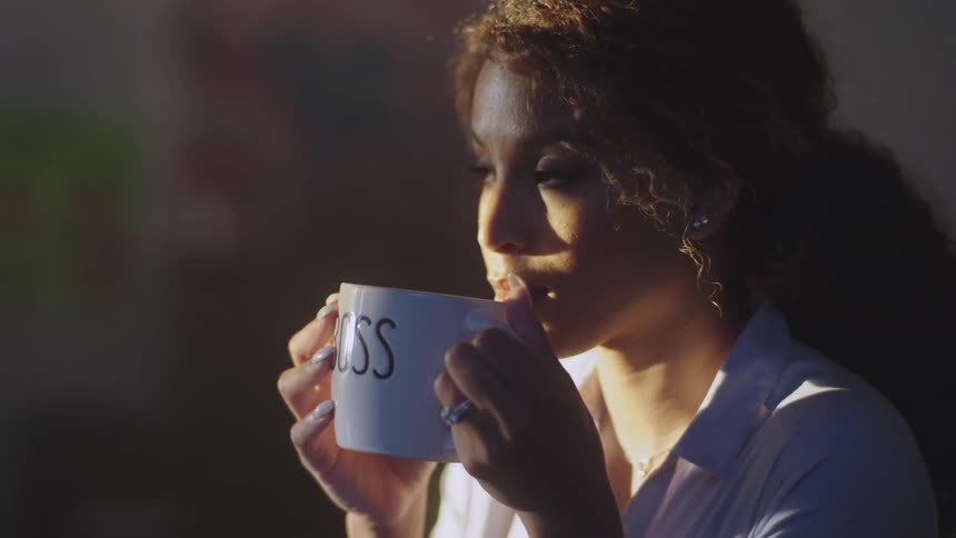 A woman drinking a mug of coffee