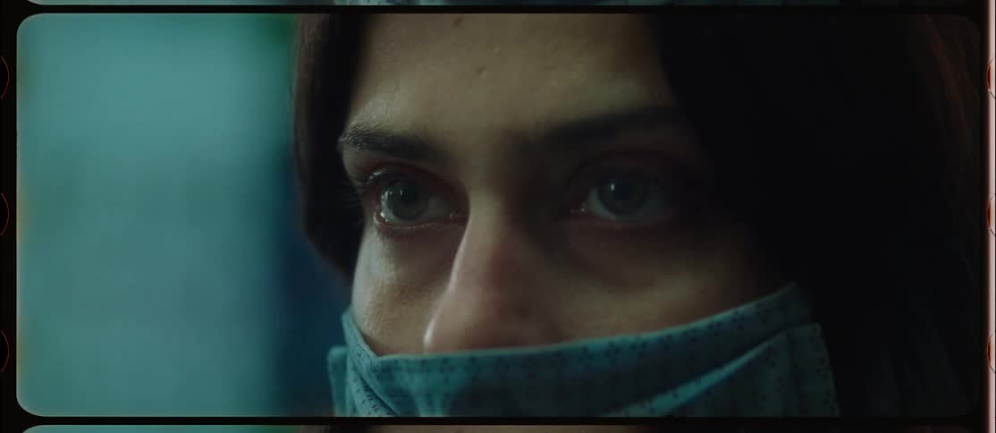 A woman turns her head looking up startled and fearful