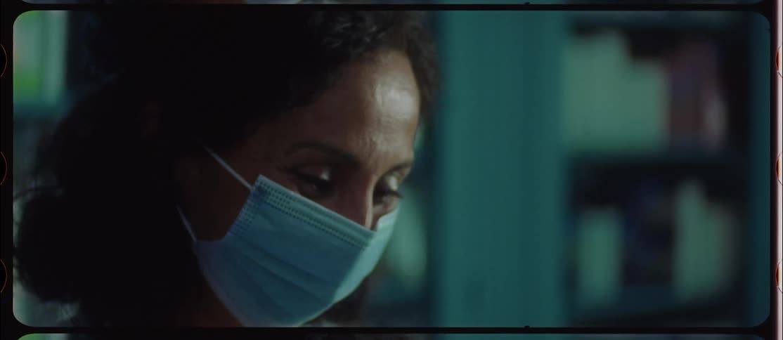 A pharmacist wears a face mask while speaking