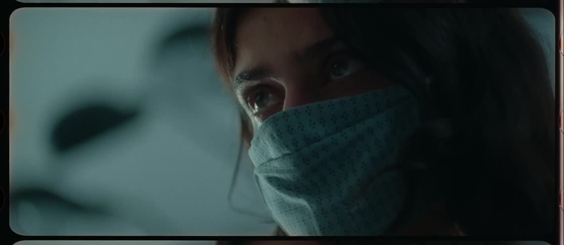 A woman wearing a mask looks up
