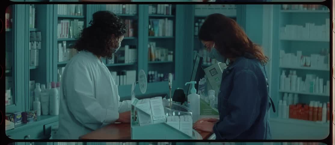 A customer walks up to the counter in a pharmacy to check out