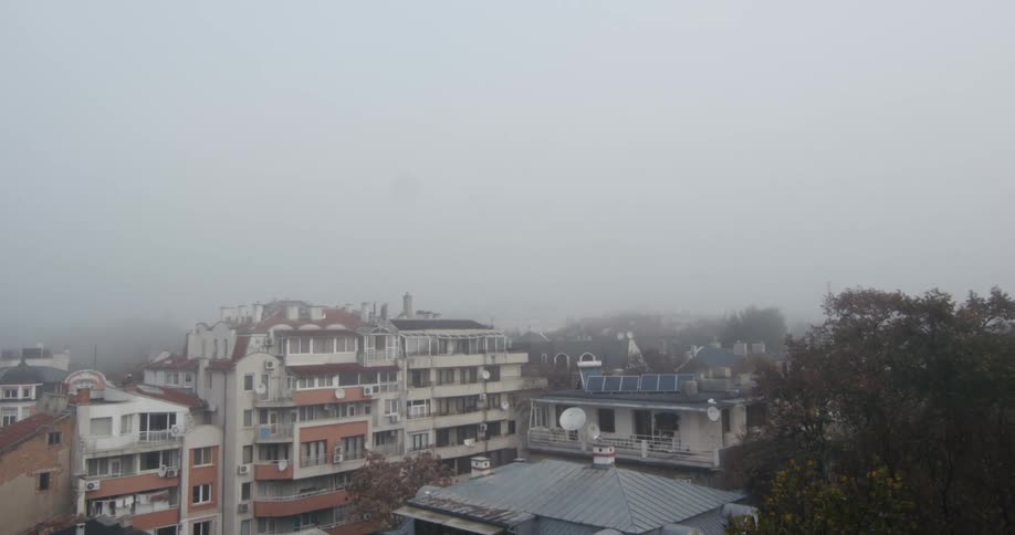 Clouds and fog hang over neighborhood apartment buildings