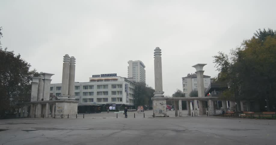People are walking in a downtown plaza on a foggy day