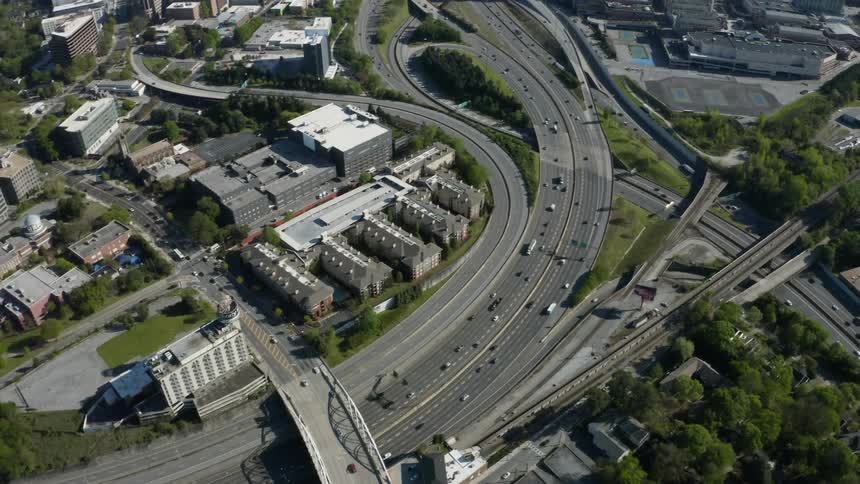 An aerial view of a city with a highway interchange