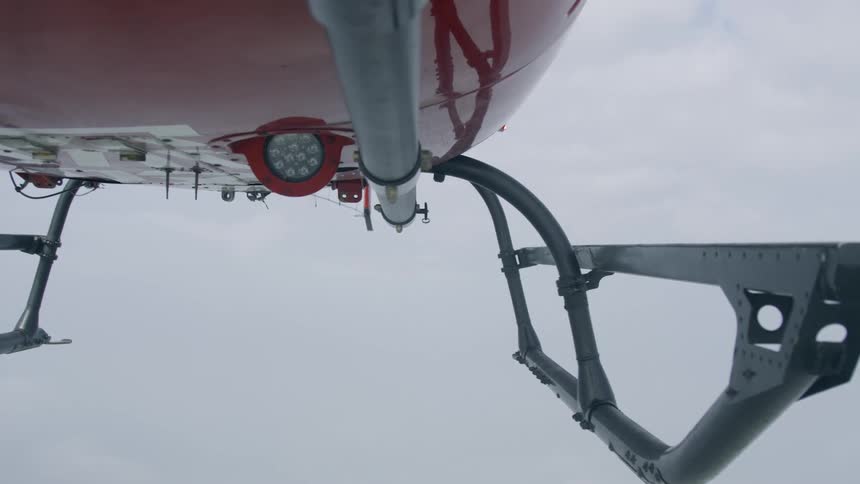 The bottom of a helicopter in flight