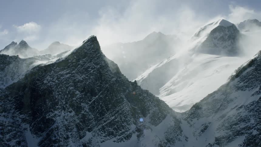 Steam and mist plume off of ice covered mountains