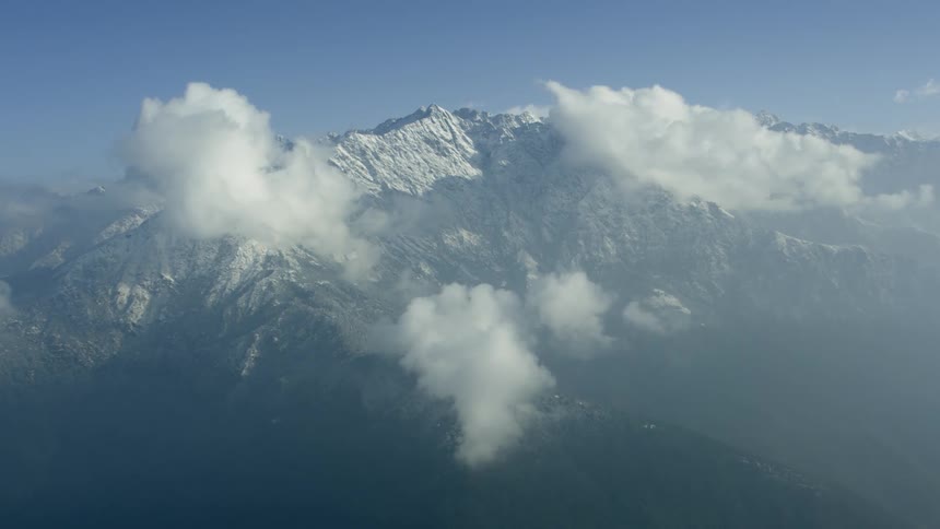 Snow covered mountains tower into the sky