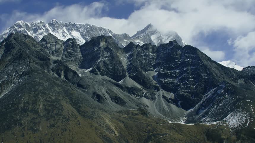 The tall mountains are covered with ice at the top