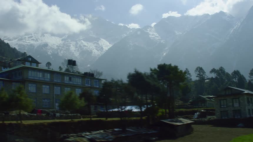 Buildings near the bottom of mountains on a sunny day