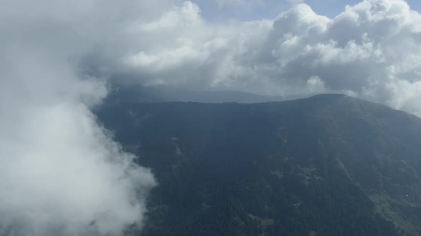 The clouds roll over the tall mountains