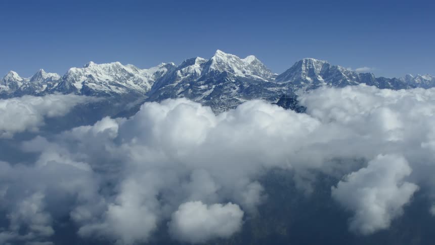 Mountain peaks above the clouds on a sunny day