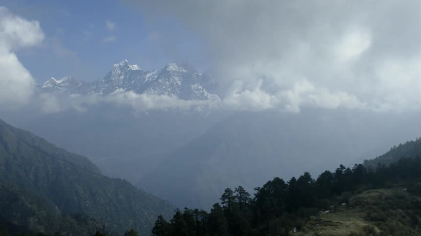 Clouds are drifting over mountains during the day