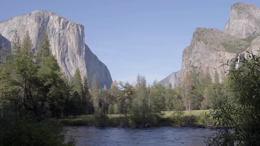 A stream sits before two mountain ranges