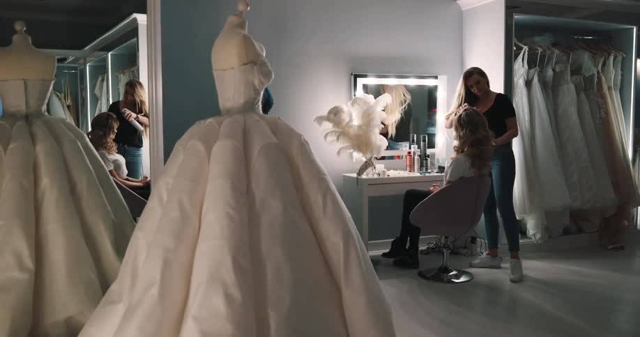 A woman doing hair and makeup on a model