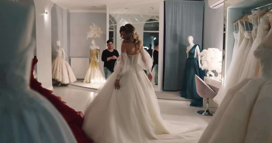 A woman modeling a dress in a studio