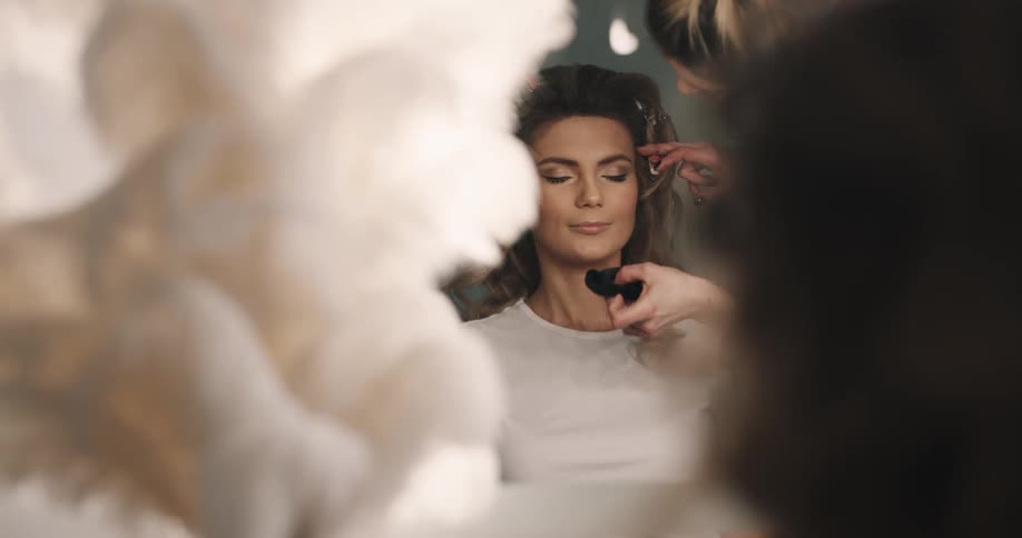 Someone is putting makeup on a womans face