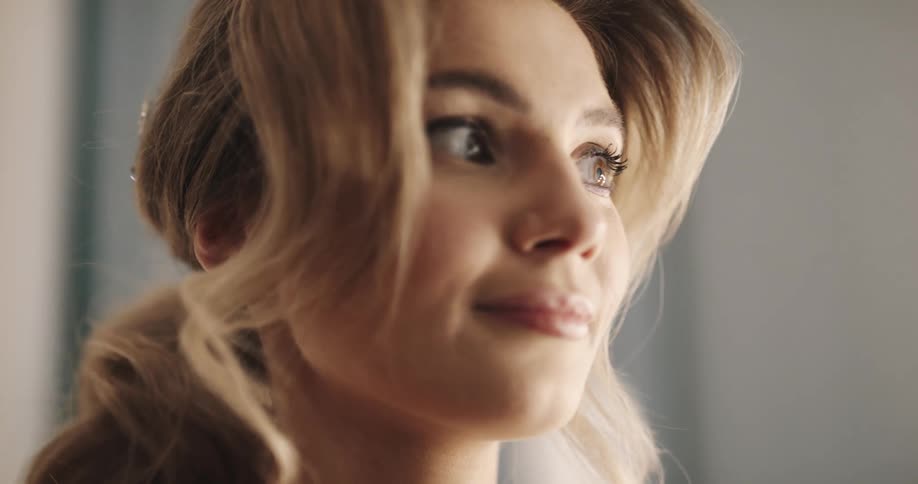 Blond haired woman is looking around smiling