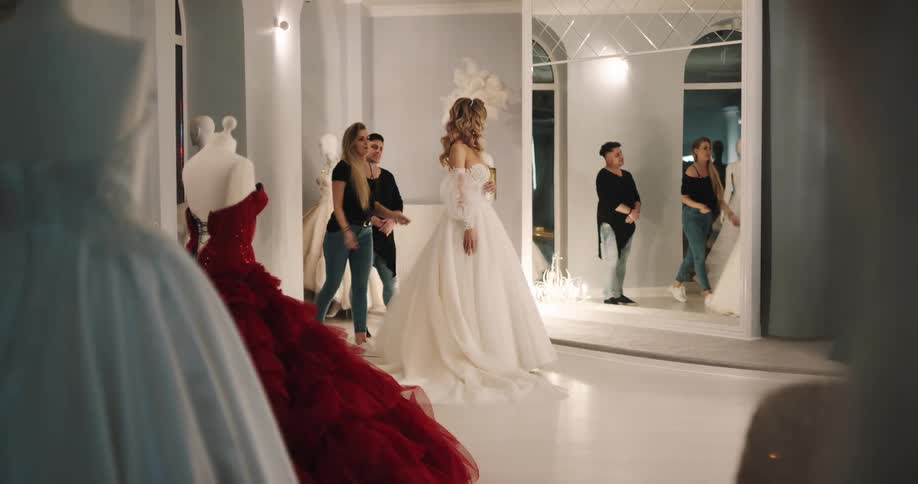 Bride modelling a wedding dress in front of a mirror