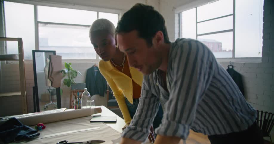 A man and woman talking about designs