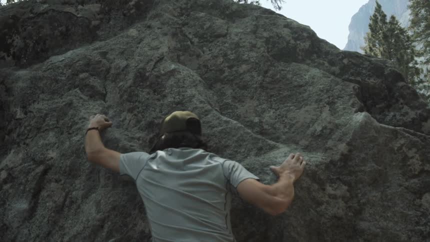 A man is near the top as he rock climbs